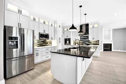 a kitchen with stainless steel appliances and white cabinets