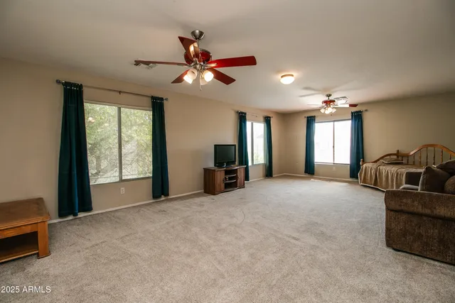 a bedroom with a bed and a television