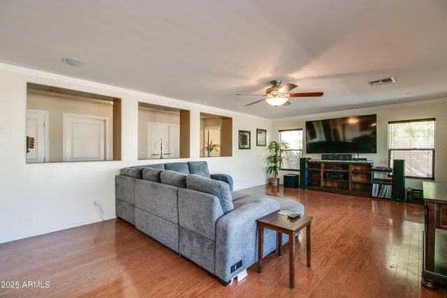 a kitchen with stainless steel appliances kitchen island granite countertop a stove a sink a dining table and chairs