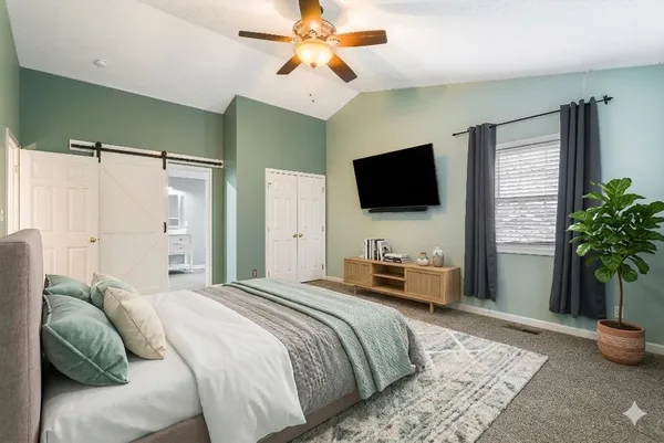 an empty room with windows and chandelier fan