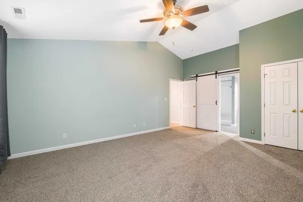 a view of a deck with a chair and floor to ceiling window