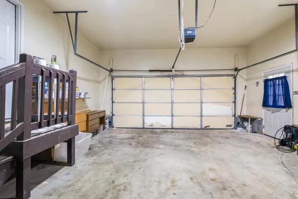 an aerial view of a house with a yard and large trees