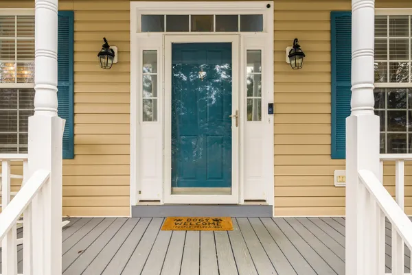 a living room with furniture a flat screen tv and a chandelier