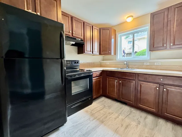 a kitchen with stainless steel appliances granite countertop a refrigerator and a sink