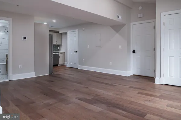 a view of empty room with wooden floor