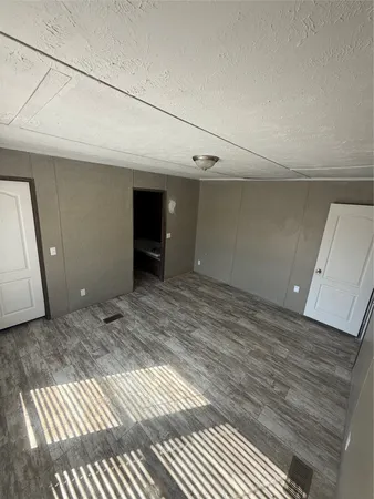 a view of a livingroom with wooden floor and cabinet