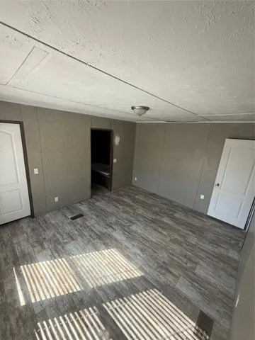a view of a livingroom with wooden floor and staircase
