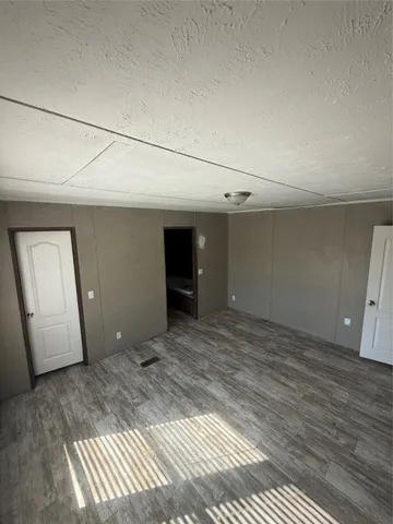 a view of a deck with a chair and iron fence