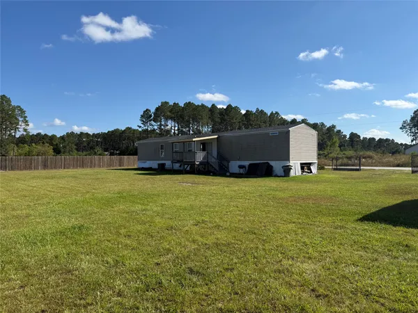 a view of a house with a big yard