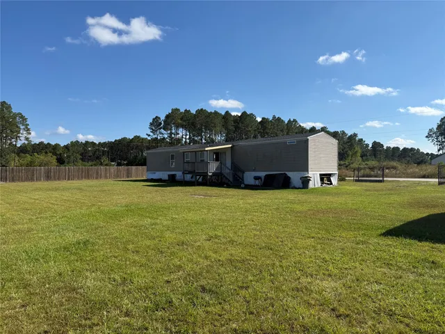 a view of a house with a big yard
