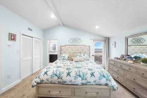 a bedroom with a bed and windows