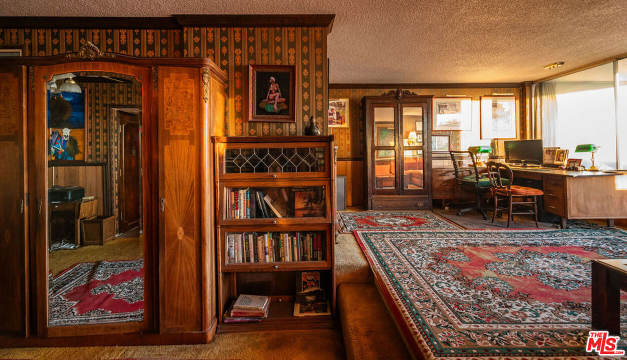8787 Shoreham Drive, Unit 607 West Hollywood, CA 90069 - Photo 11 of 25 a living room with furniture a rug and a window