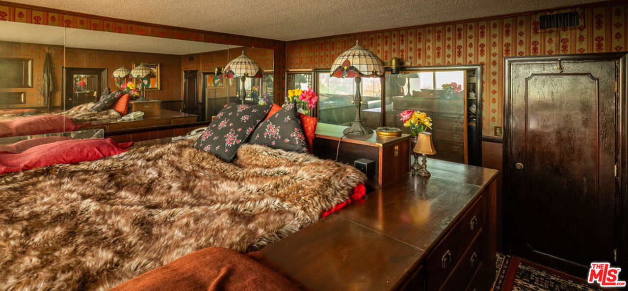 8787 Shoreham Drive, Unit 607 West Hollywood, CA 90069 - Photo 15 of 25 a bed room with a bed and gym equipment