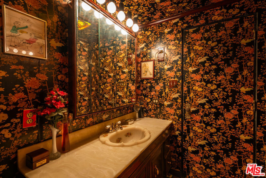 8787 Shoreham Drive, Unit 607 West Hollywood, CA 90069 - Photo 16 of 25 a bathroom with a granite countertop sink and vanity
