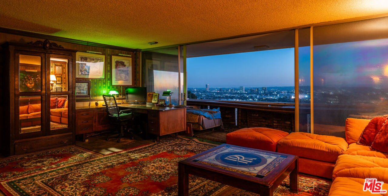 8787 Shoreham Drive, Unit 607 West Hollywood, CA 90069 - Photo 22 of 25 a living room with furniture a rug and a floor to ceiling window