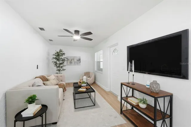 a living room with furniture and a flat screen tv