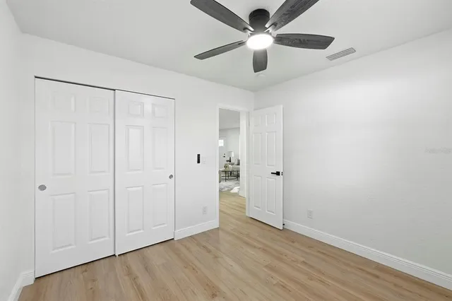 a view of an empty room and wooden floor