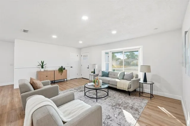 a living room with furniture and a large window
