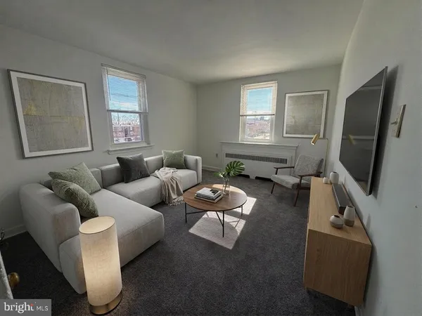 a living room with furniture and a flat screen tv