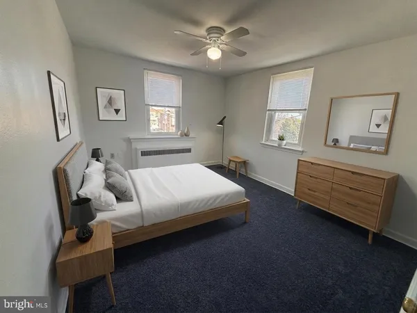 a bedroom with a bed couch and window