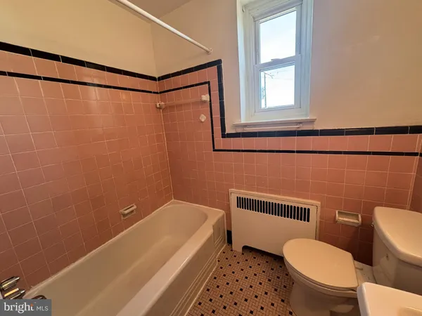 a bathroom with a toilet a sink and a bathtub