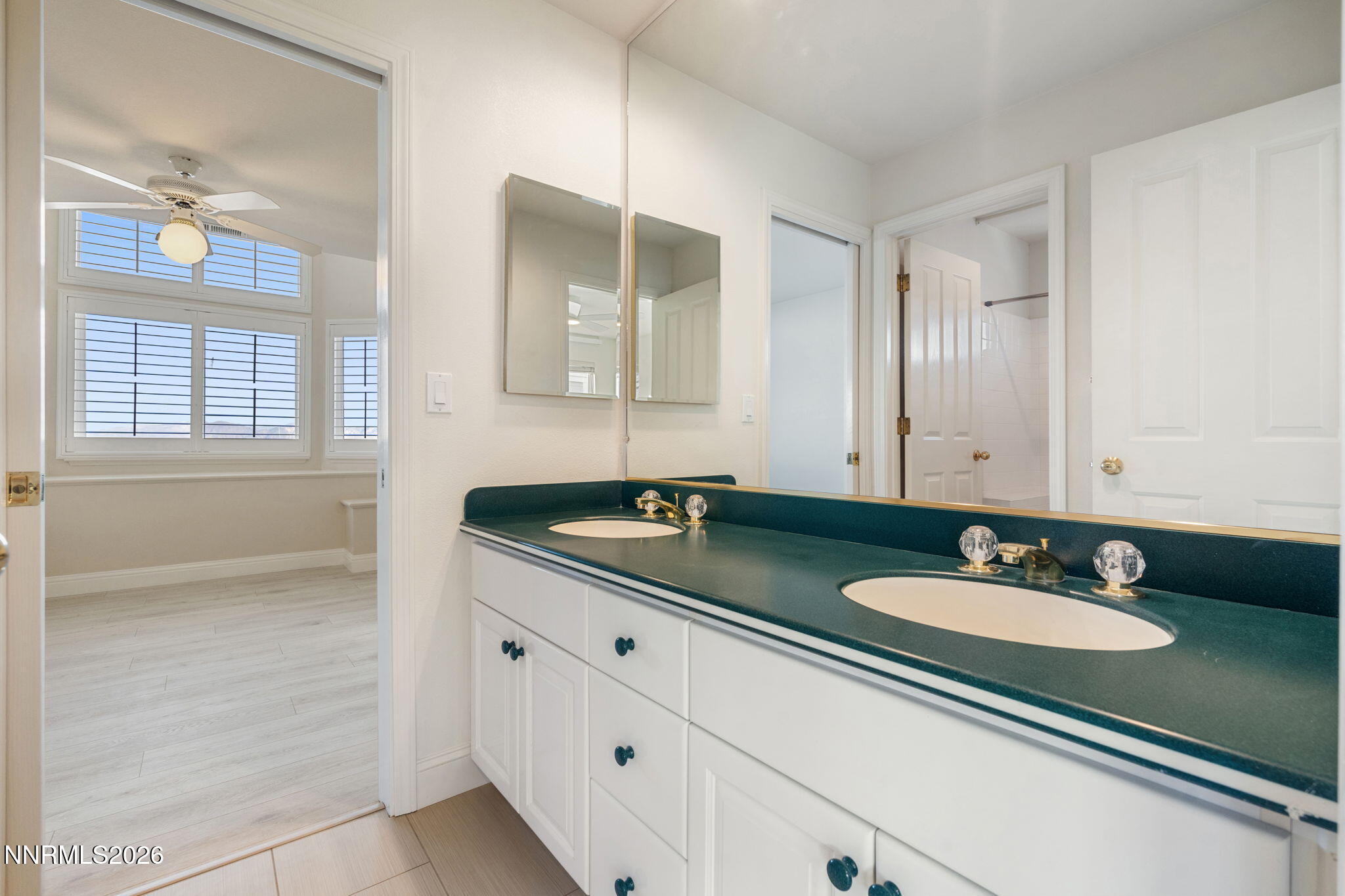6186 Squires Lane Reno, NV 89519 - Photo 32 of 57 a bathroom with a sink double vanity and a mirror
