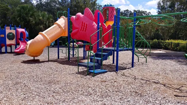 a view of swimming pool with a yard and green space