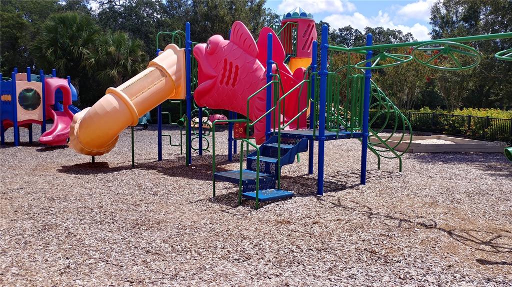 3936 Bramblewood Loop Spring Hill, FL 34609 - Photo 27 of 30 a backyard of a house with table and chairs