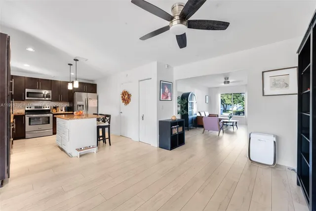 a living room with furniture and kitchen view