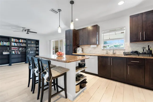 a kitchen with a table chairs refrigerator and cabinets