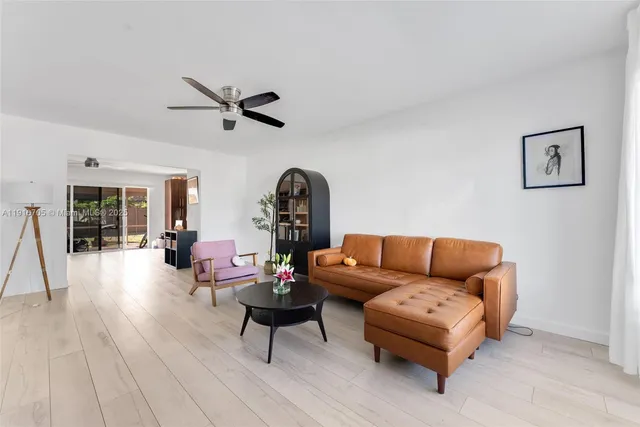 a living room with furniture a rug and a chandelier