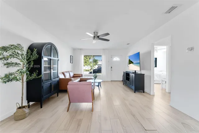 a living room with furniture bathtub and a window