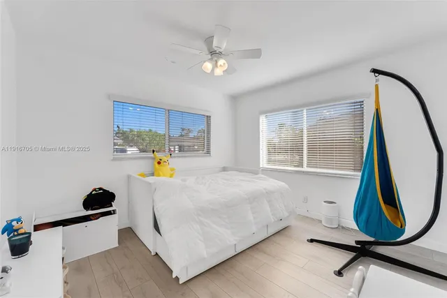 a bed sitting in a bedroom next to a window