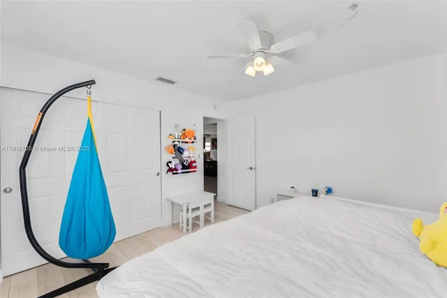 a bed room with a bed and a chandelier