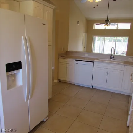a bathroom with a granite countertop sink a mirror and a shower