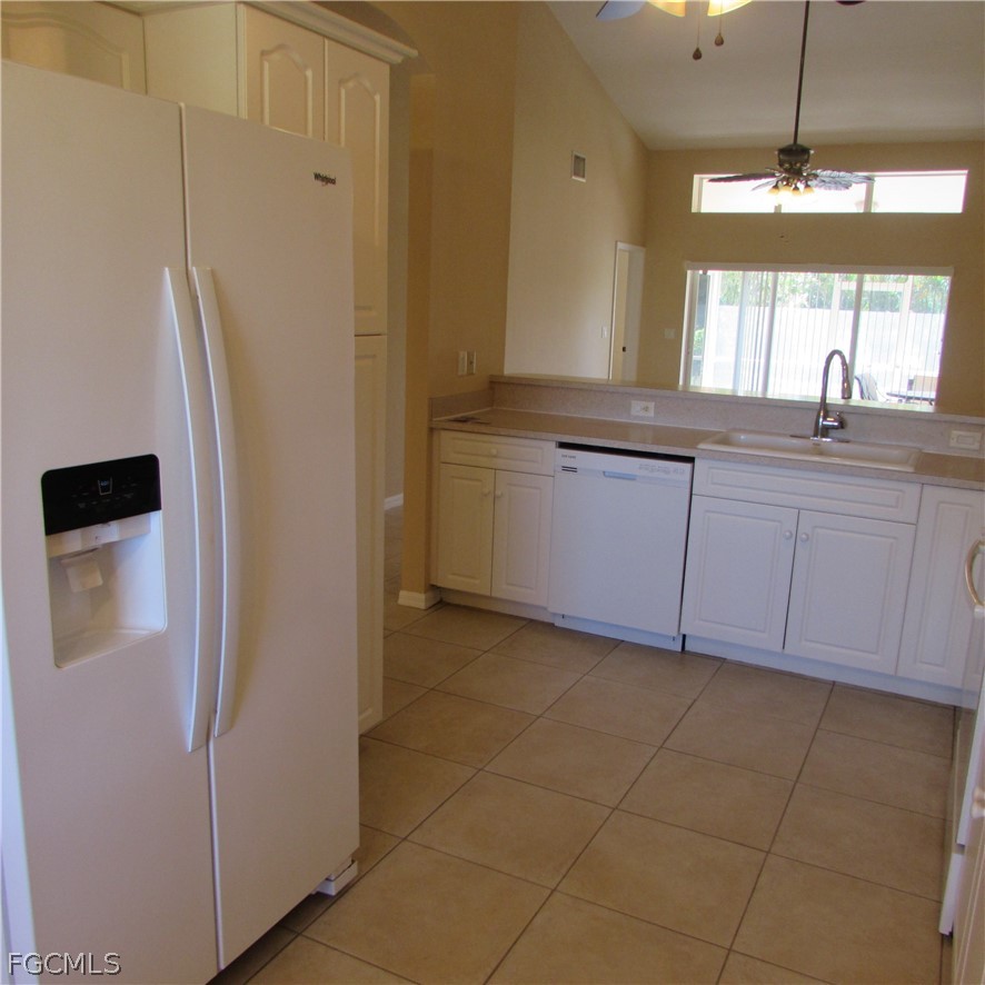 5773 Marina Road Bokeelia, FL 33922 - Photo 13 of 27 a bathroom with a granite countertop sink a mirror and a shower