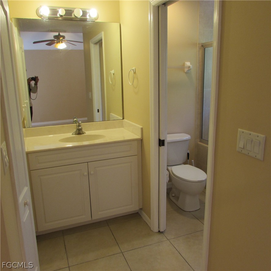 5773 Marina Road Bokeelia, FL 33922 - Photo 20 of 27 a bathroom with a toilet sink and mirror