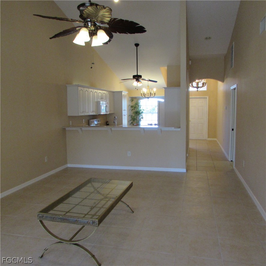 5773 Marina Road Bokeelia, FL 33922 - Photo 25 of 27 a view of a livingroom with a chandelier furniture and windows