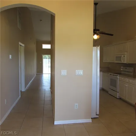 a view of a kitchen with a refrigerator and cabinets