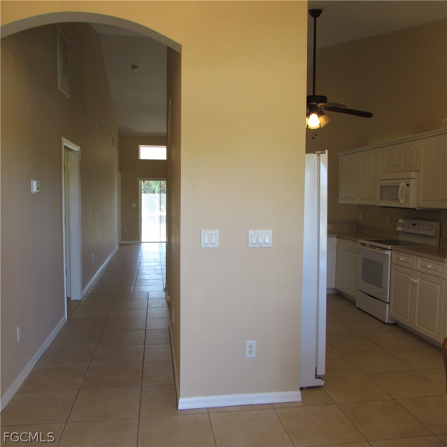 5773 Marina Road Bokeelia, FL 33922 - Photo 6 of 27 a view of a kitchen with a refrigerator and cabinets