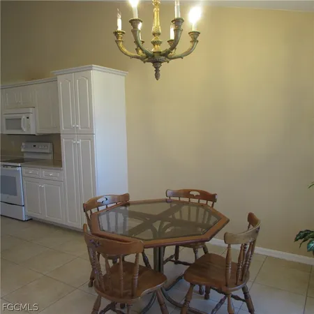 a view of a dining room with furniture and chandelier