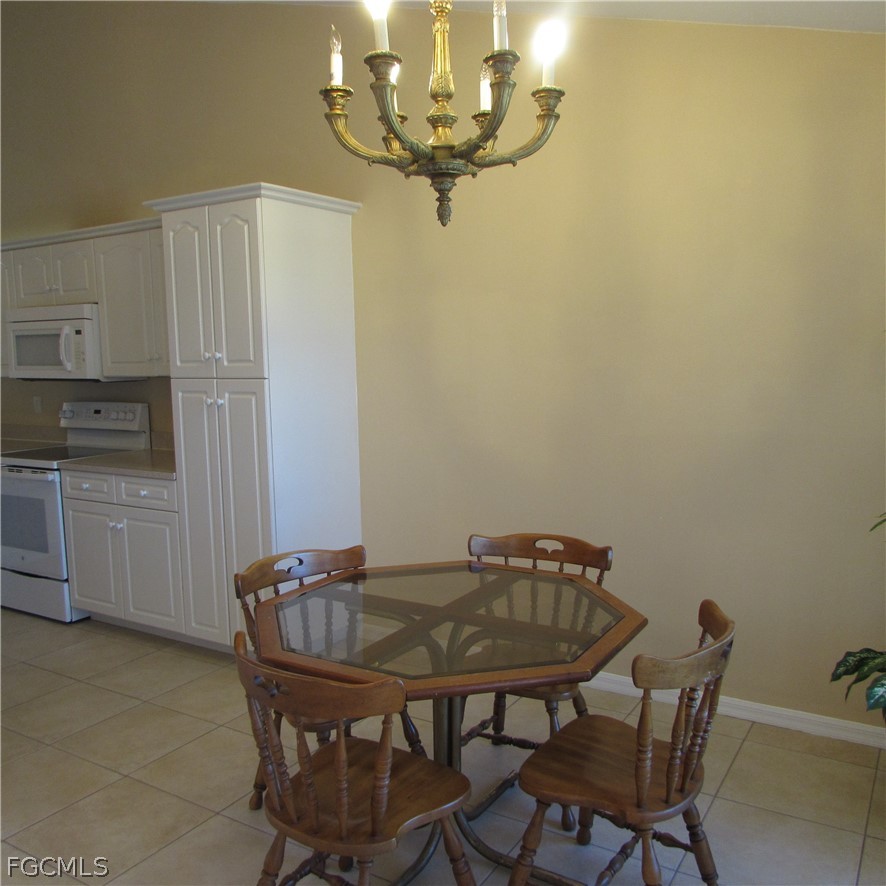 5773 Marina Road Bokeelia, FL 33922 - Photo 7 of 27 a view of a dining room with furniture and chandelier