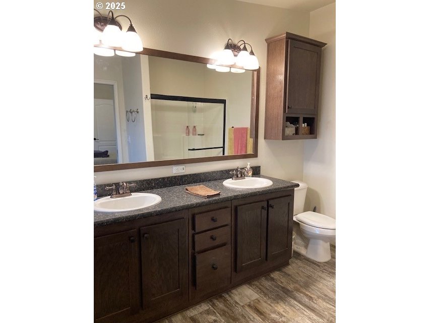 3075 Southwest River View Drive Pendleton, OR 97801 - Photo 16 of 34 a bathroom with a double vanity sink and a mirror