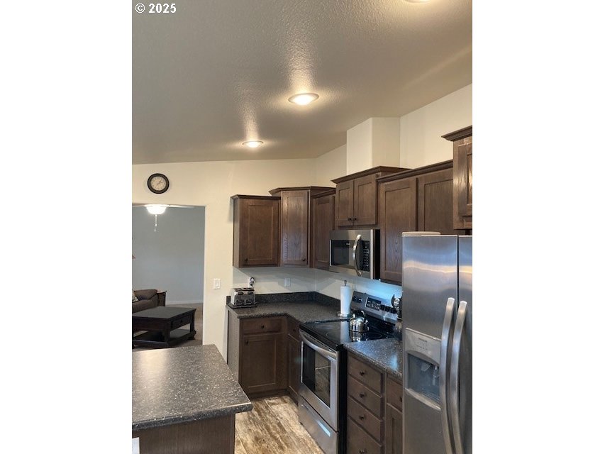 3075 Southwest River View Drive Pendleton, OR 97801 - Photo 9 of 34 a kitchen with stainless steel appliances granite countertop a refrigerator and a stove