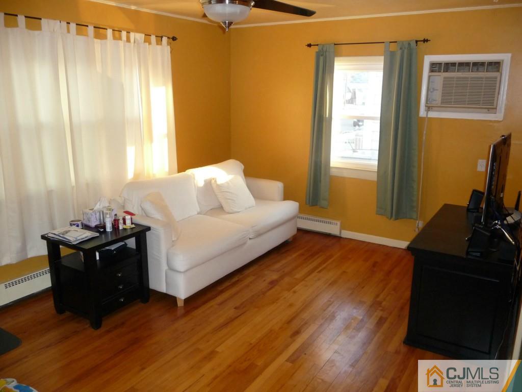 159 East Hill Road Colonia, NJ 07067 - Photo 2 of 21 a living room with a bed furniture and a flat tv screen