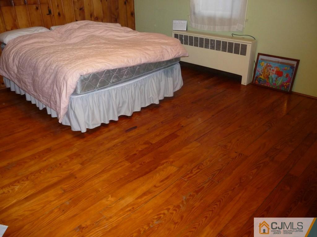159 East Hill Road Colonia, NJ 07067 - Photo 17 of 21 a bedroom with a bed and wooden floor