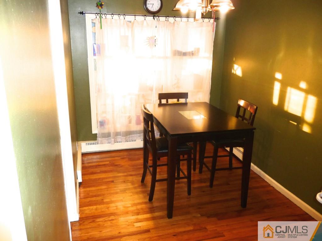 159 East Hill Road Colonia, NJ 07067 - Photo 3 of 21 a view of a dining room with furniture and wooden floor