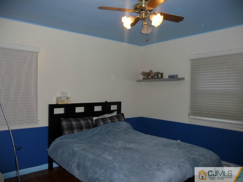 159 East Hill Road Colonia, NJ 07067 - Photo 10 of 21 a bedroom with a bed and a chandelier