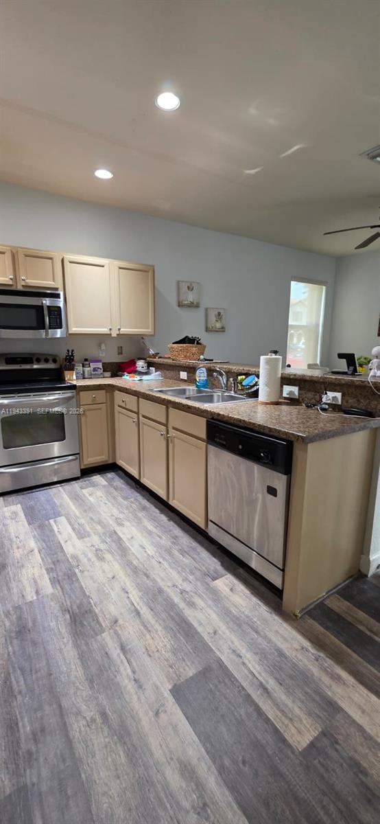 3203 Southeast 7th Street Homestead, FL 33033 - Photo 12 of 44 a kitchen with stainless steel appliances granite countertop a stove a sink and a refrigerator