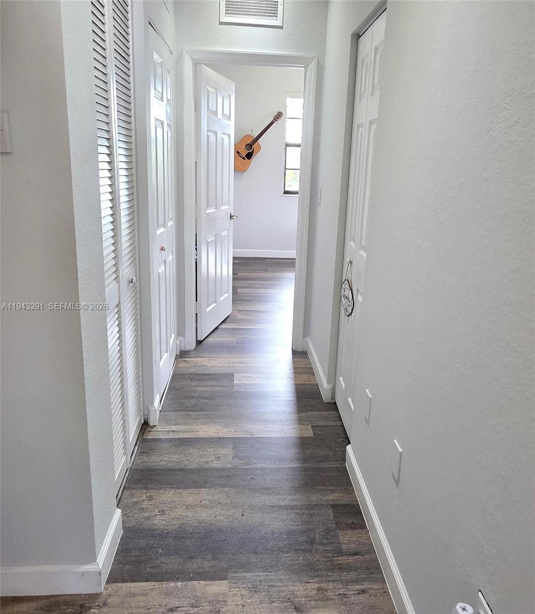 3203 Southeast 7th Street Homestead, FL 33033 - Photo 23 of 44 a view of a hallway with wooden floor and staircase